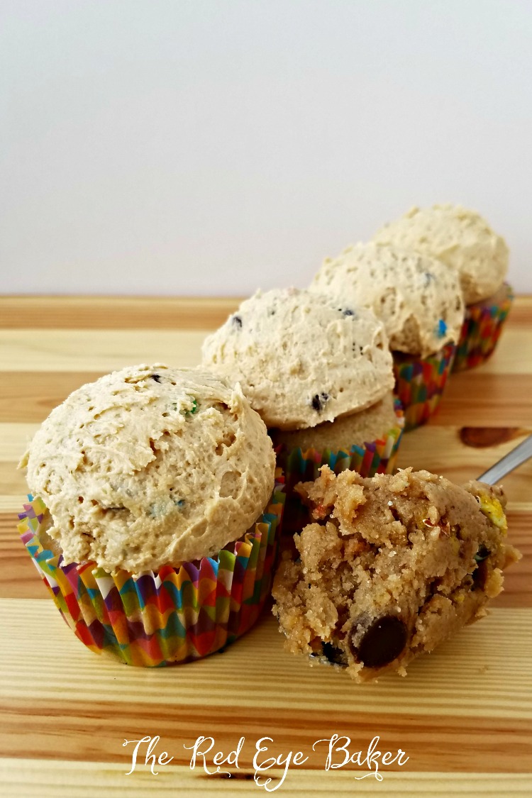 Monster Cookie Dough Cupcakes | Bring out the kid in you with these delicious Monster Cookie Dough Cupcakes, filled with edible cookie dough, M&M's, chocolate chips, and PB frosting!